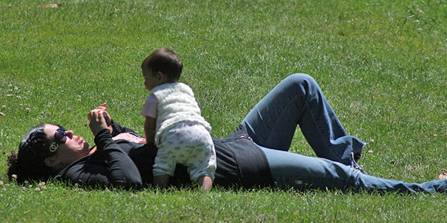 A mother and her baby in a grass field